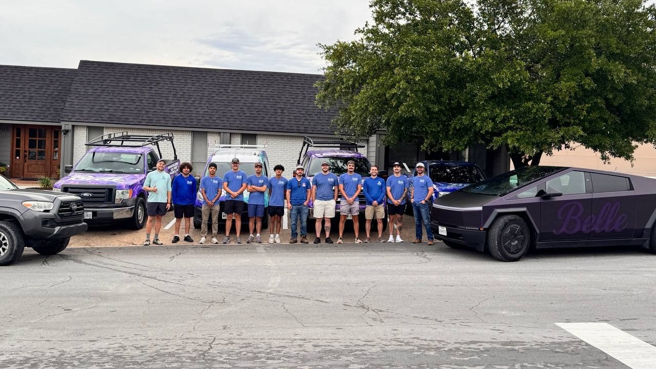 Belle team gathered with service vehicles outside the Belle facility